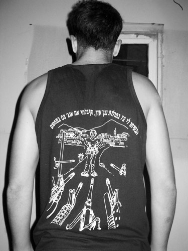 IDF paratrooper's t-shirt shows army rifles facing down a bomber outside Nablus.