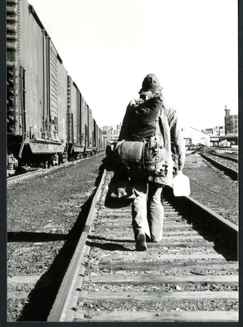 Rolling Nowhere: photo of man walking on train tracks
